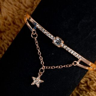 Gold bracelet with gemstones and star charm
