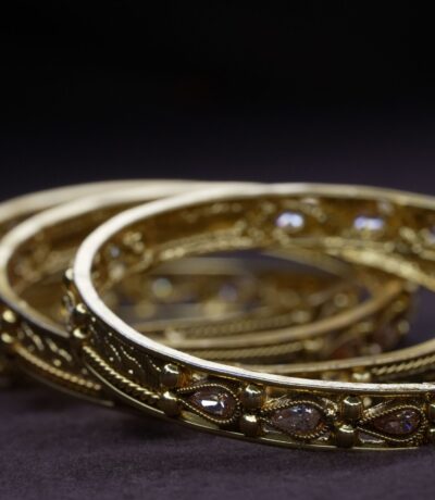 Ornate gold bangles with gemstone accents