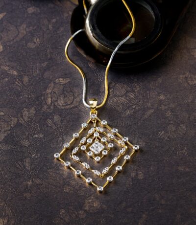 Gold and diamond necklace on ornate surface
